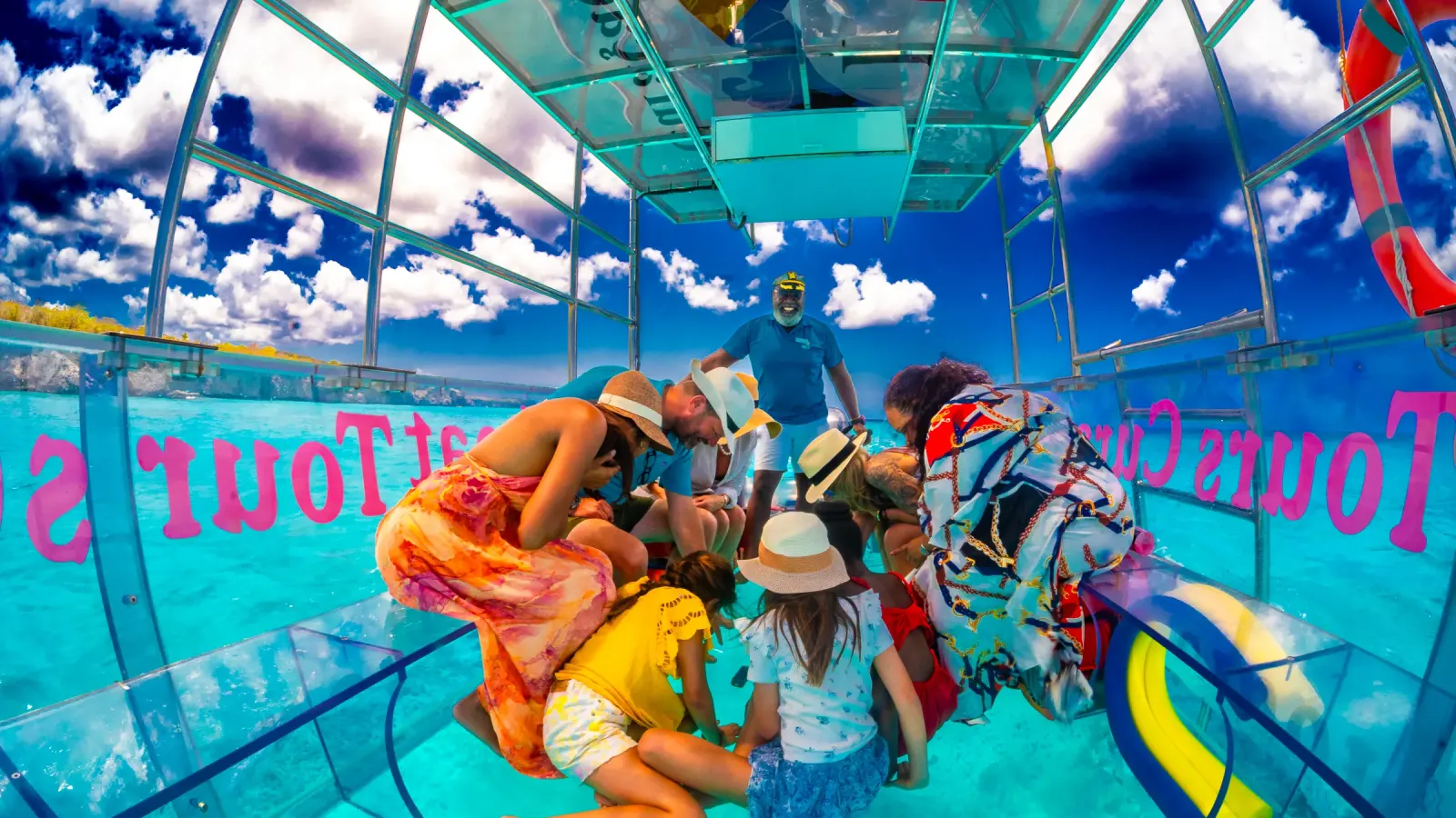 Guests aboard the Clearboat looking down through the transparent floor